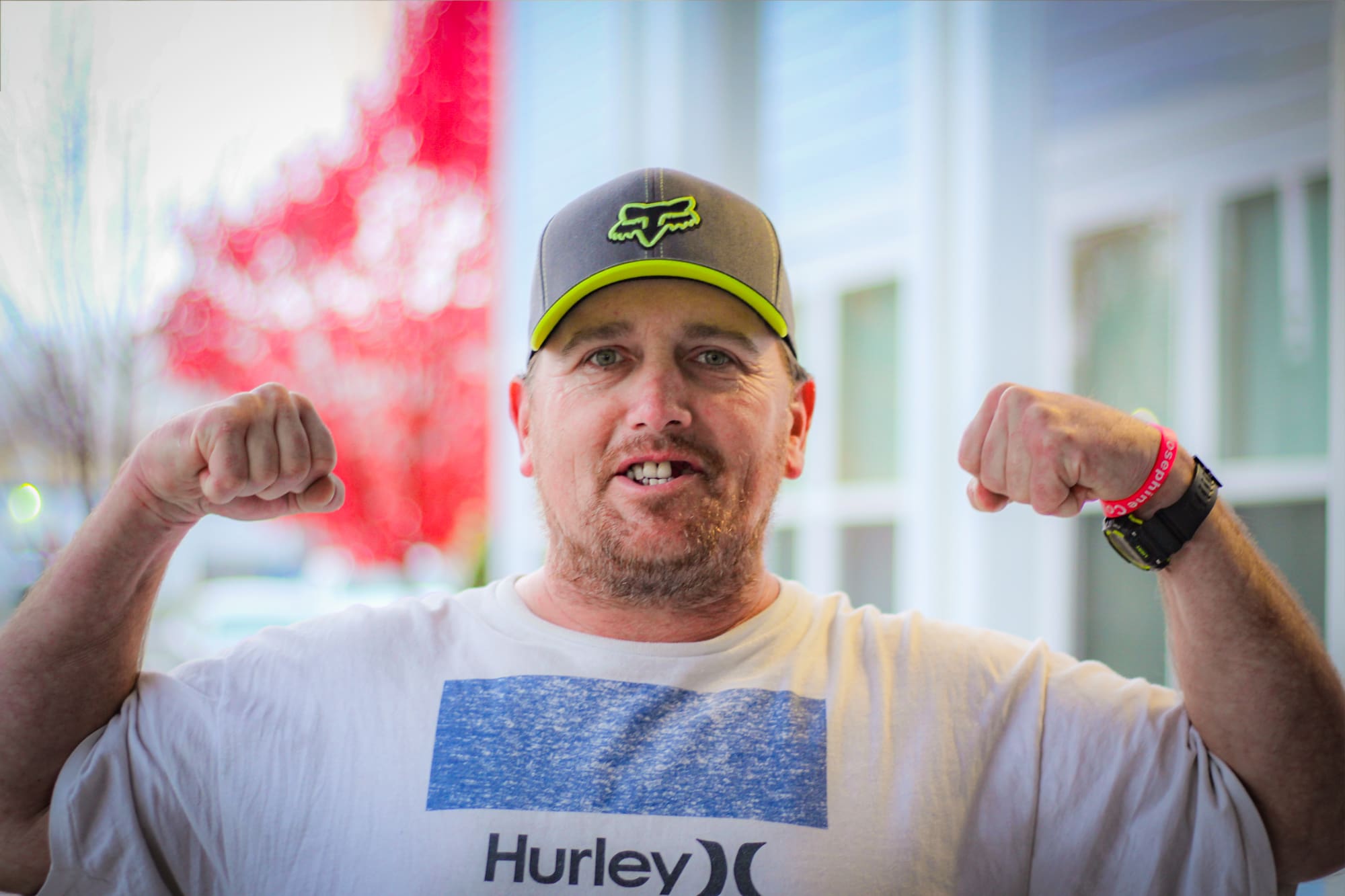 Chris Sorenson poses, flexing his arms in front of the Grants Pass Gospel Rescue Mission.