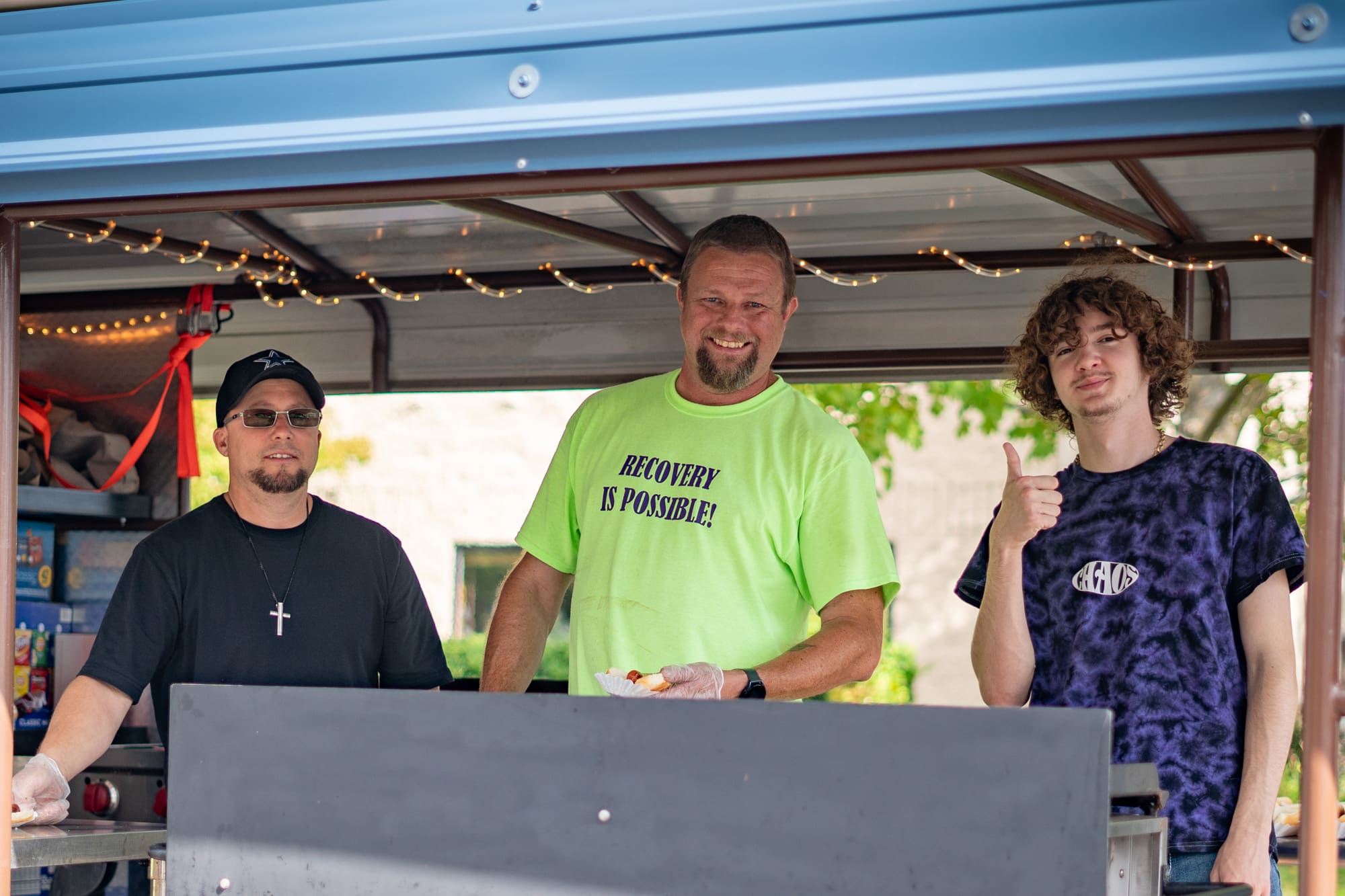 Men's Coordinator Bobby Galli serves hot dogs at the 2023 Recovery Fair