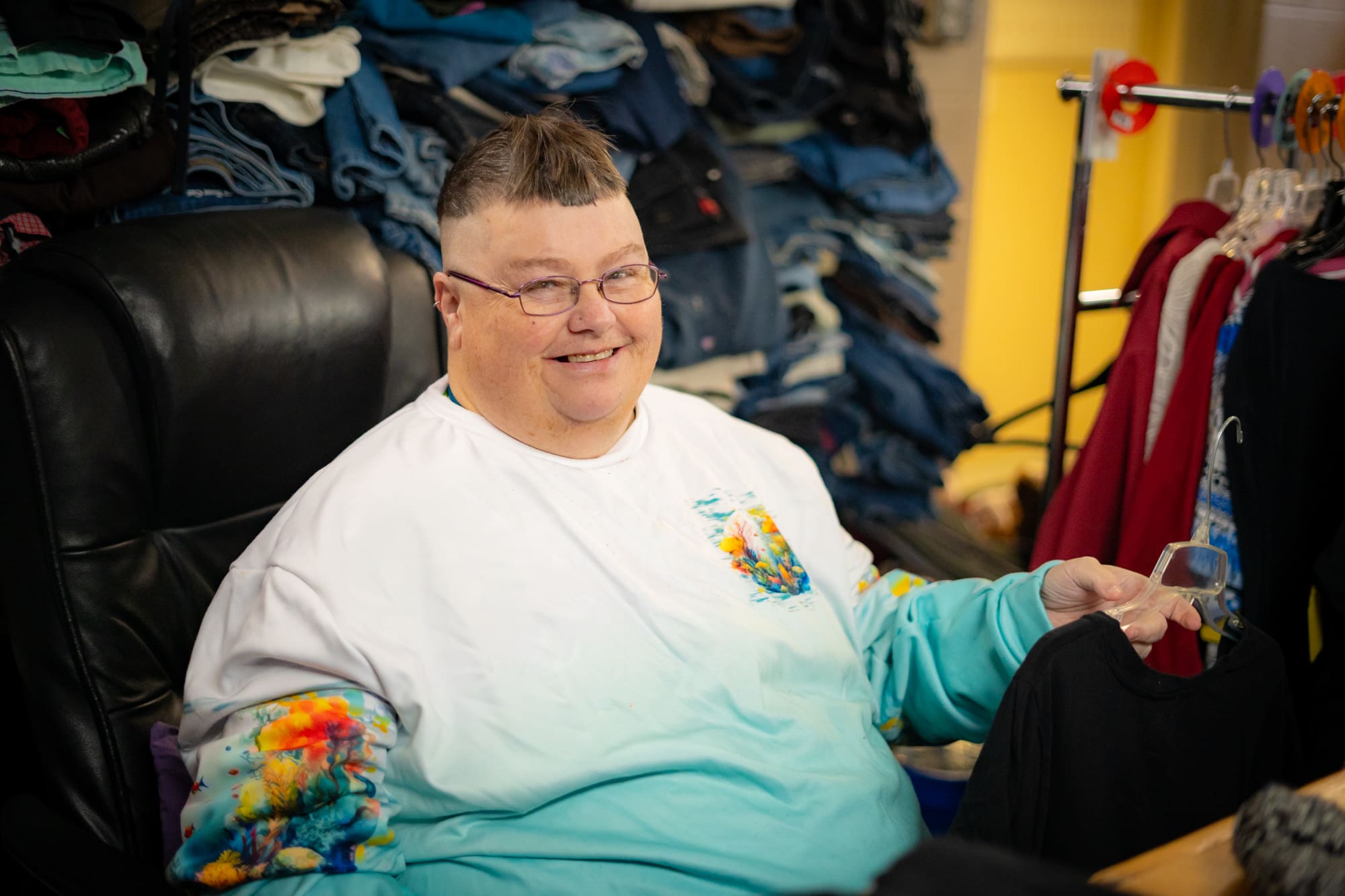 Cathy sorts clothing at Booth Street Thrift Store